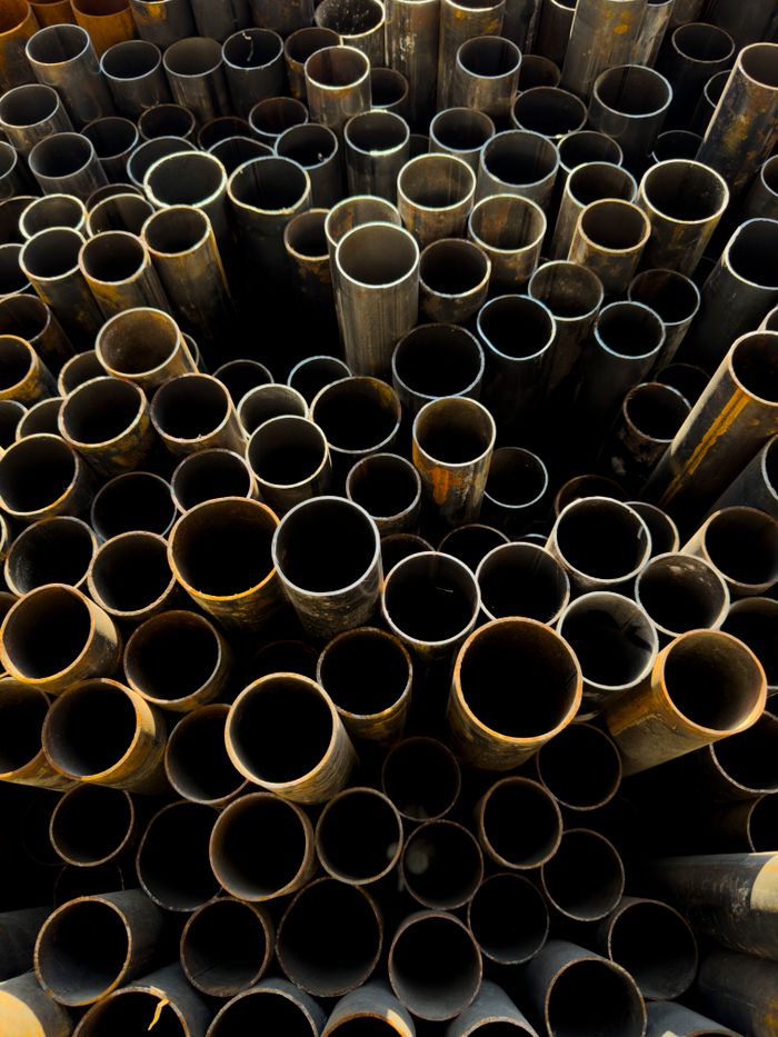 pexels photo 33653735 A detailed view of stacked rusty metal pipes in an industrial setting, showcasing decay and grunge.
