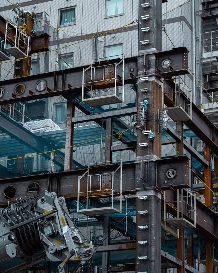 who-we-are Detailed view of a Japanese construction site showcasing steel beams and modern architecture.